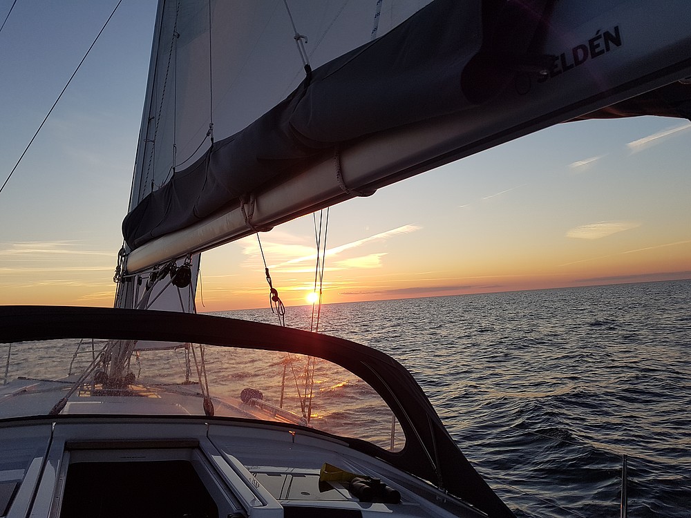 Blick vom Segelboot auf die Untergehende Sonne am Horizont